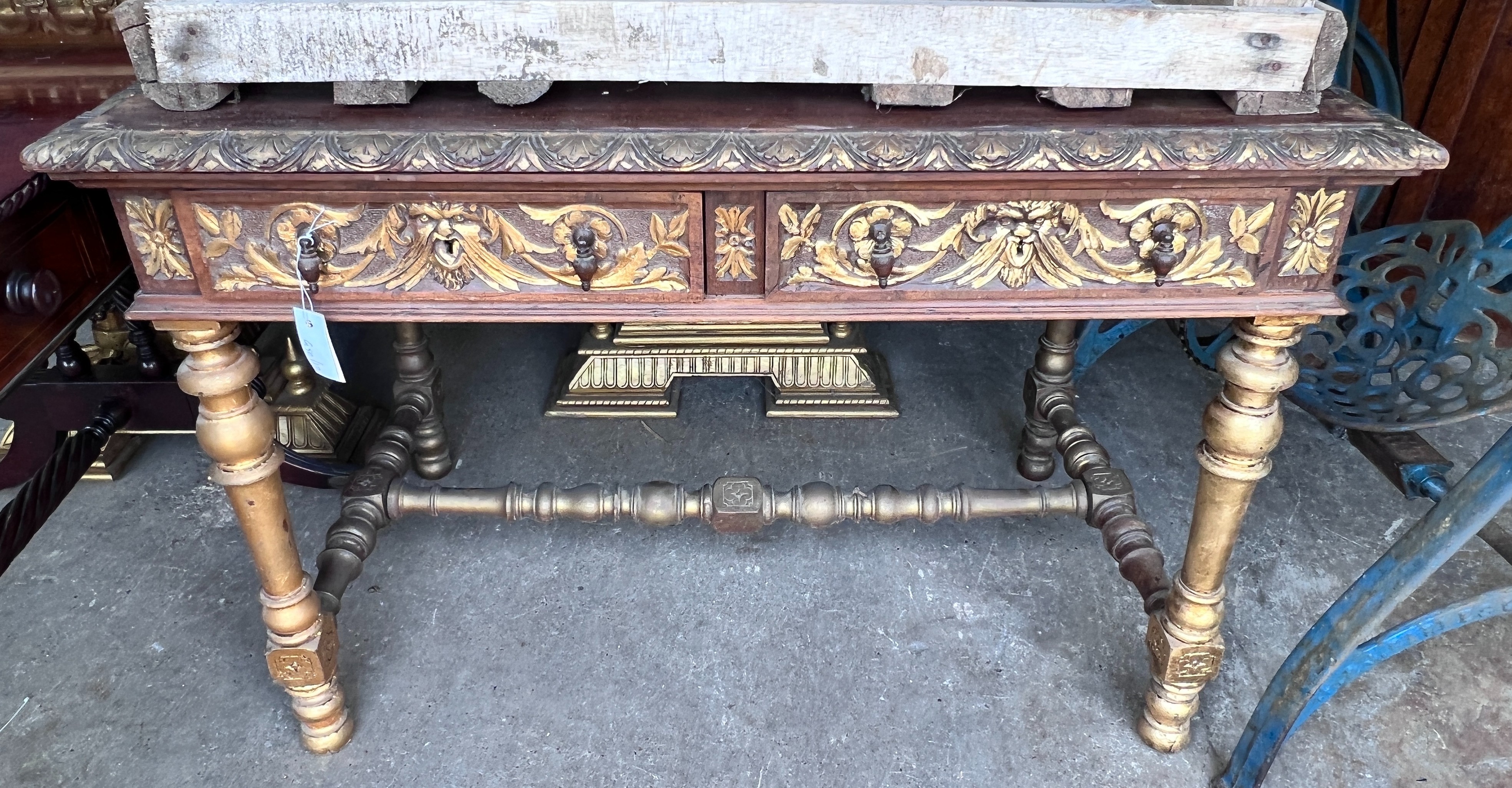 An early 20th century Flemish parcel gilt oak two drawer side table, width 109cm, depth 64cm, height 78cm